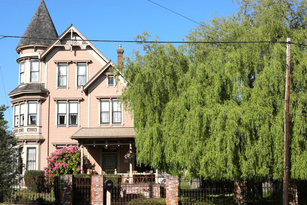 Exterior of Victorian House with three stories and a tower