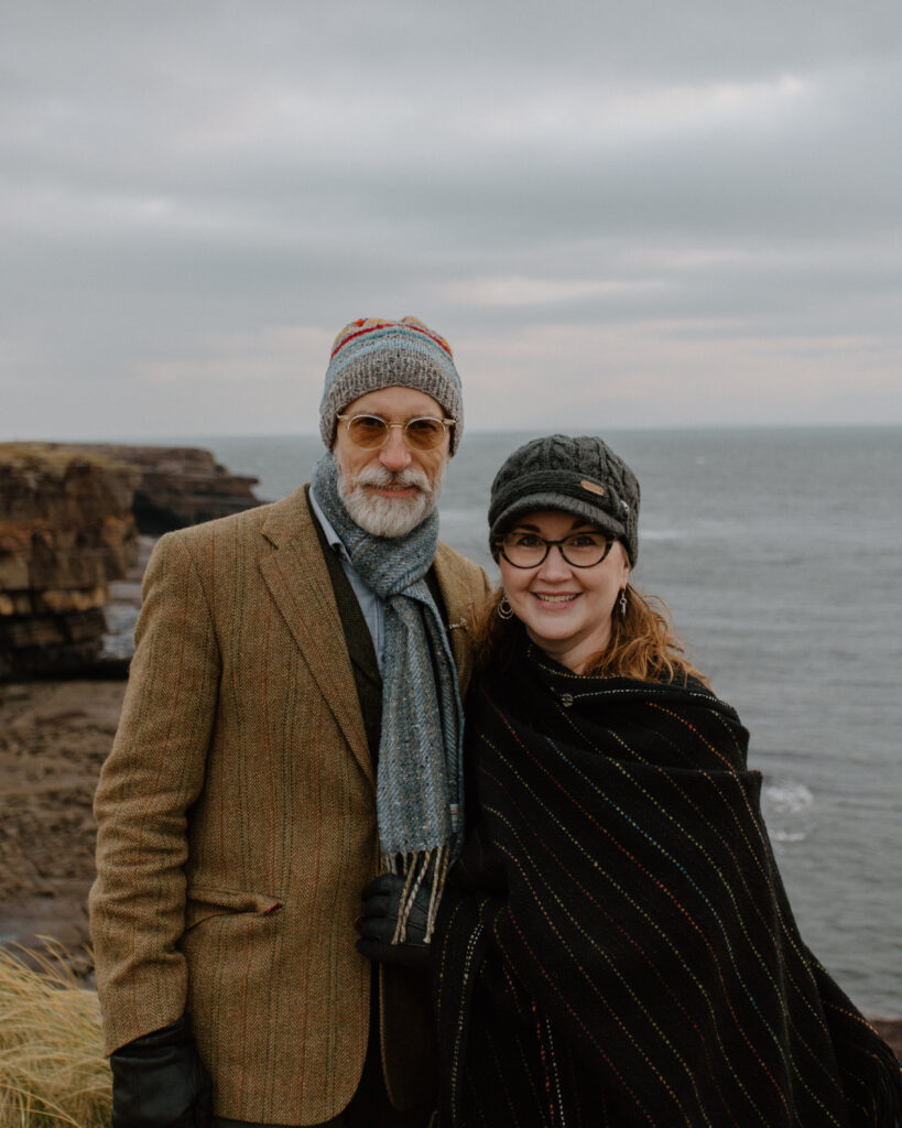 Owners Joseph and Zhenya Lavy stand in front of cliffs and the ocean